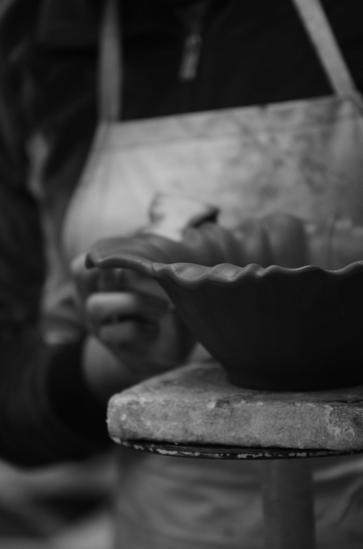 Hands working on ceramic